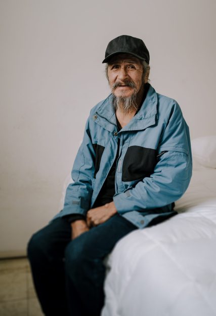 man sitting on a bed in whitesand first nation, ontario