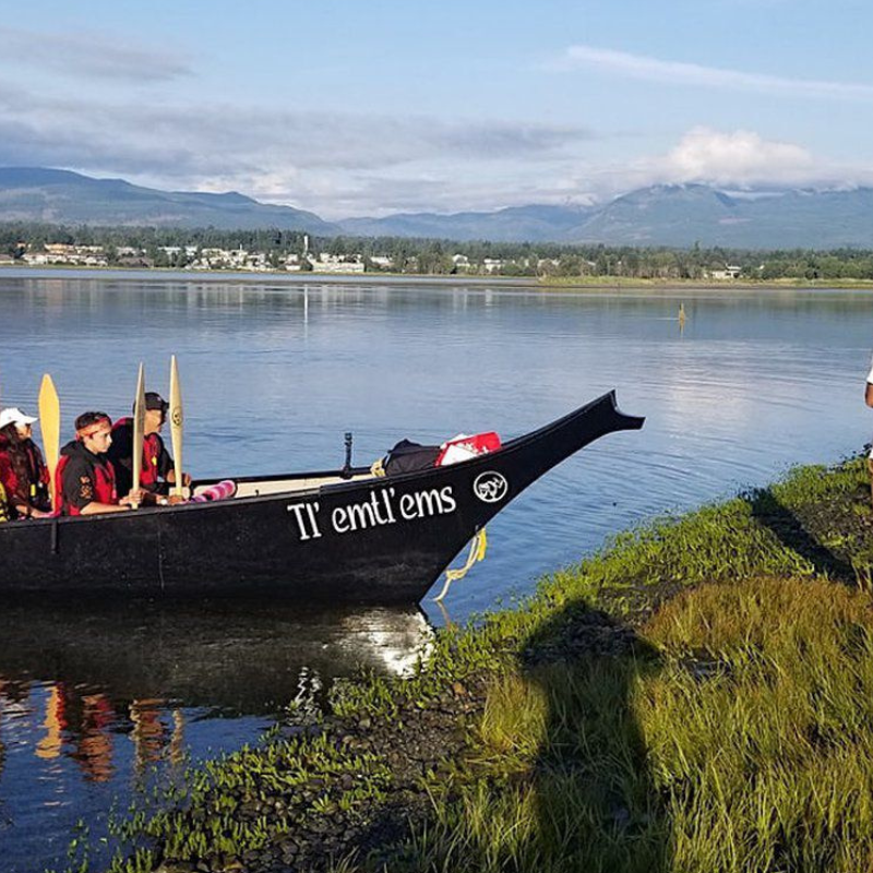 a large canoe labelled Tlemtlems on a tribal journey in British Columbia