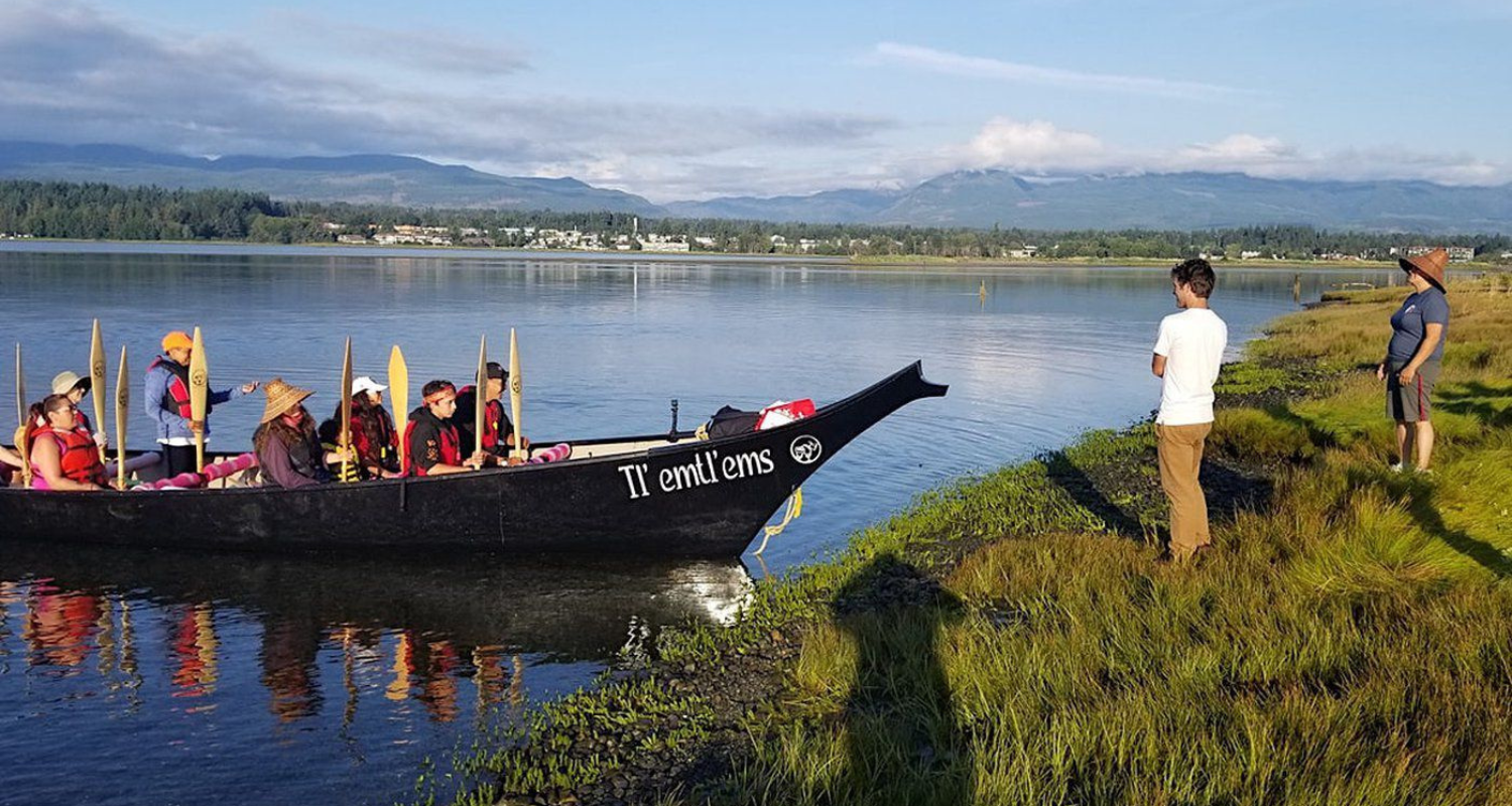 a large canoe labelled Tlemtlems on a tribal journey in British Columbia