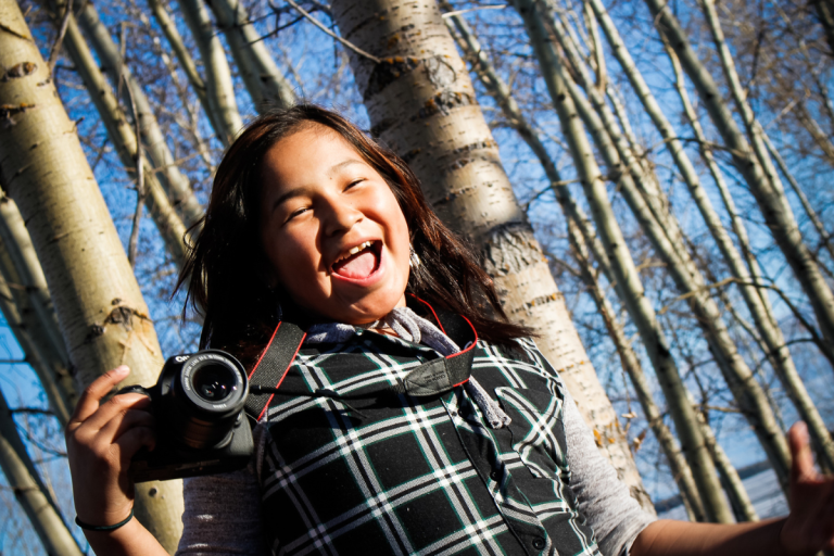Untitled design (18) girl with camera in northern Ontario first Nation Eabametoong