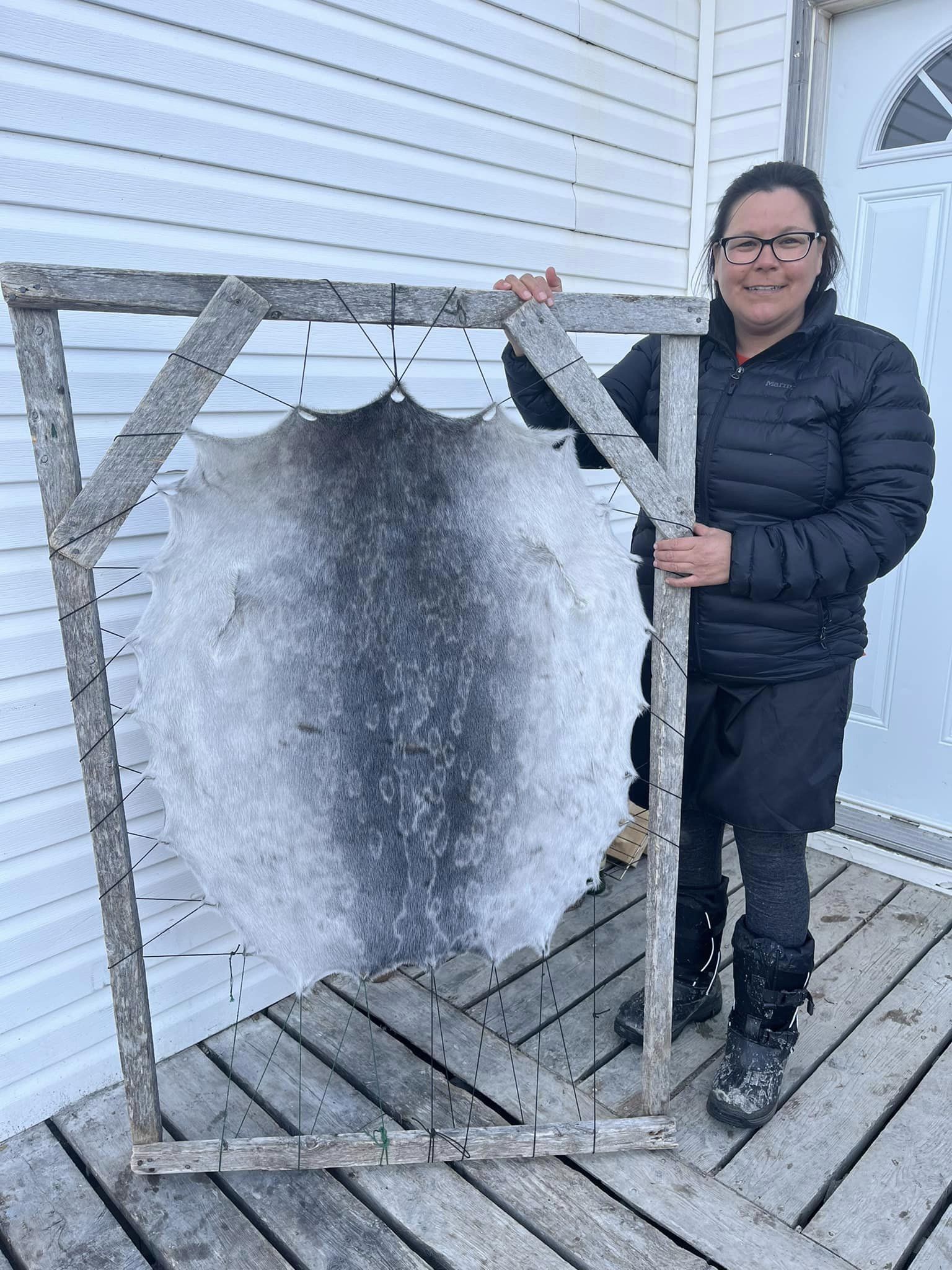 Woman posing with a clean stretched out sealskin