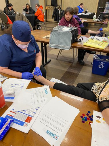 Nurse looking at a patients foot