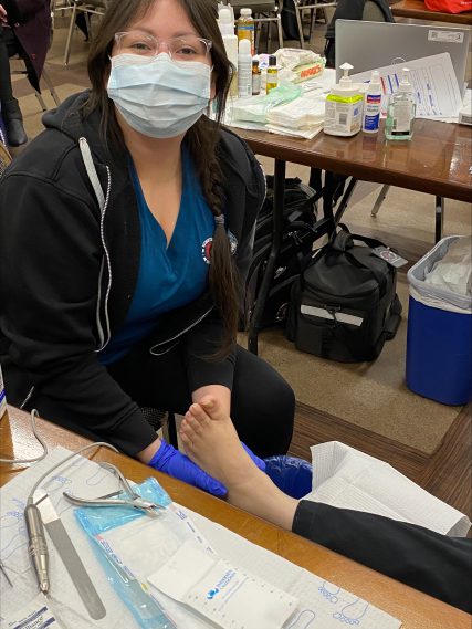 Nurse looking at a patients foot