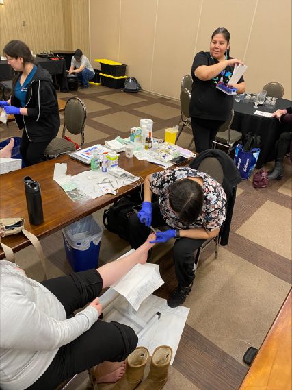 Nurse looking at a patients foot