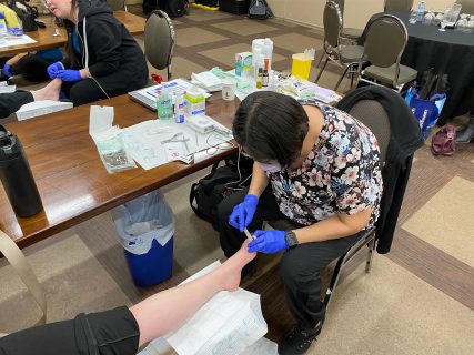 Nurse looking at a patients foot